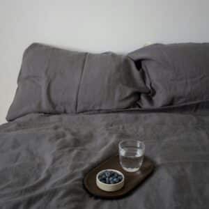 Wooden Tray With Blueberries and Glass of Water in Bed