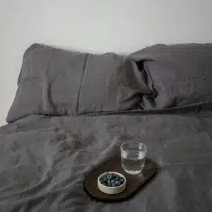 Wooden Tray With Blueberries and Glass of Water in Bed
